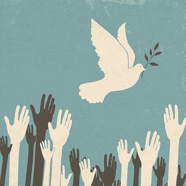 Drawing of a peace dove, some white and colored hands reaching up
