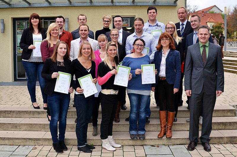 Group of students from Nordhausen University of Applied Sciences with certificates at the Germany Scholarship award ceremony in front of a university building.