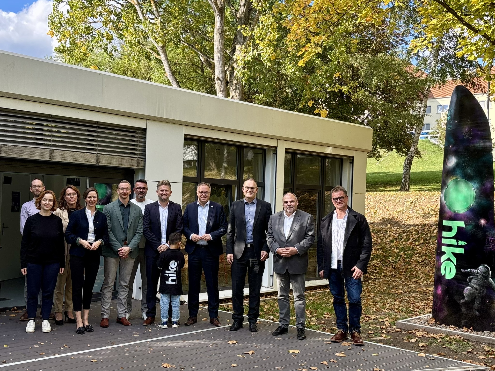 Gruppe von Menschen vor Gebäude.