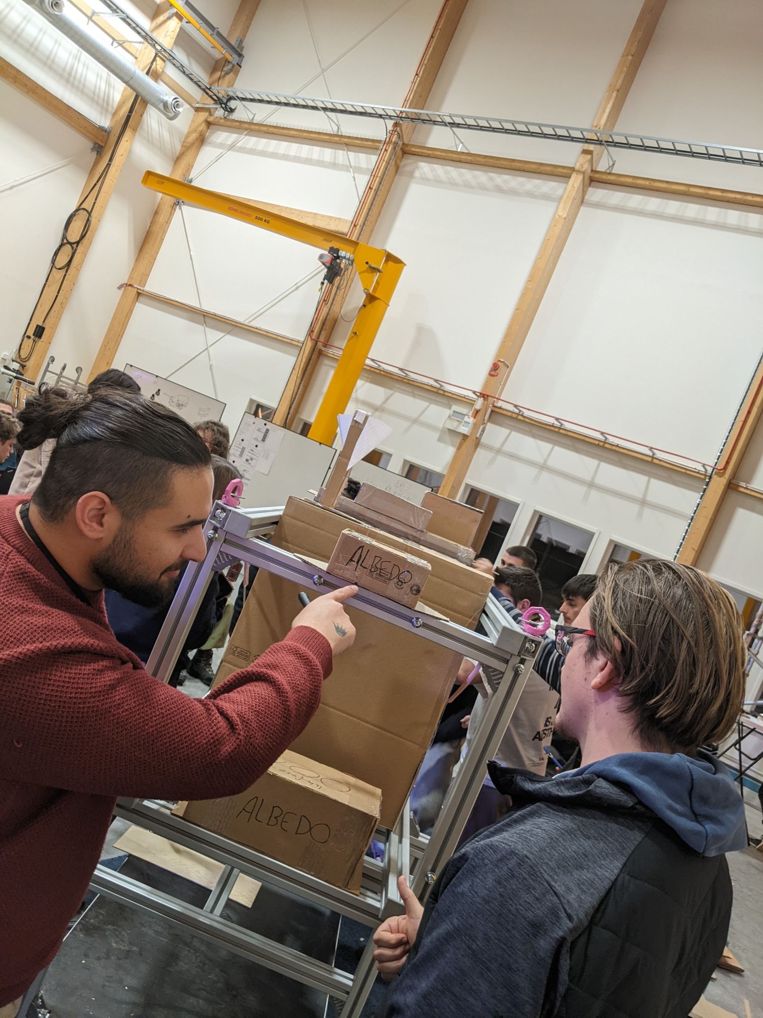 Students of the BEXUS-ALBEDO project discuss the integration of technical components into the gondola of the stratospheric balloon