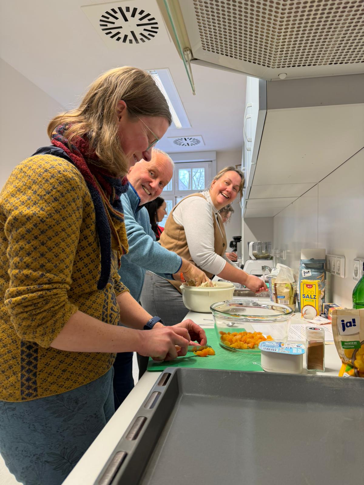 People cooking in a modern kitchen.