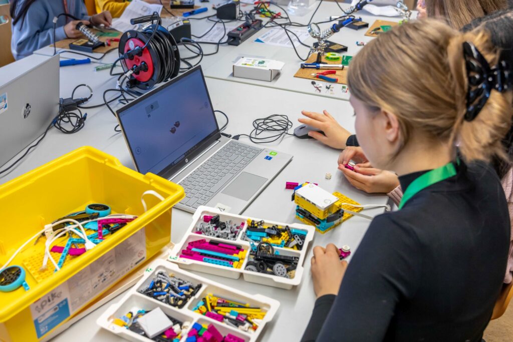 Girls build with Lego and technology.