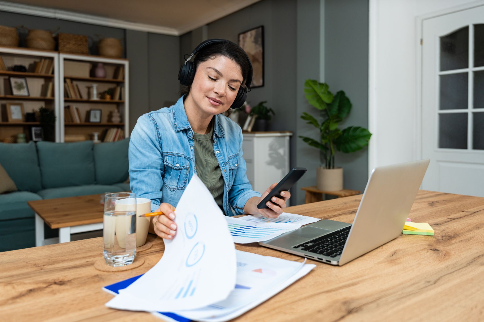 Woman working at table with laptop.