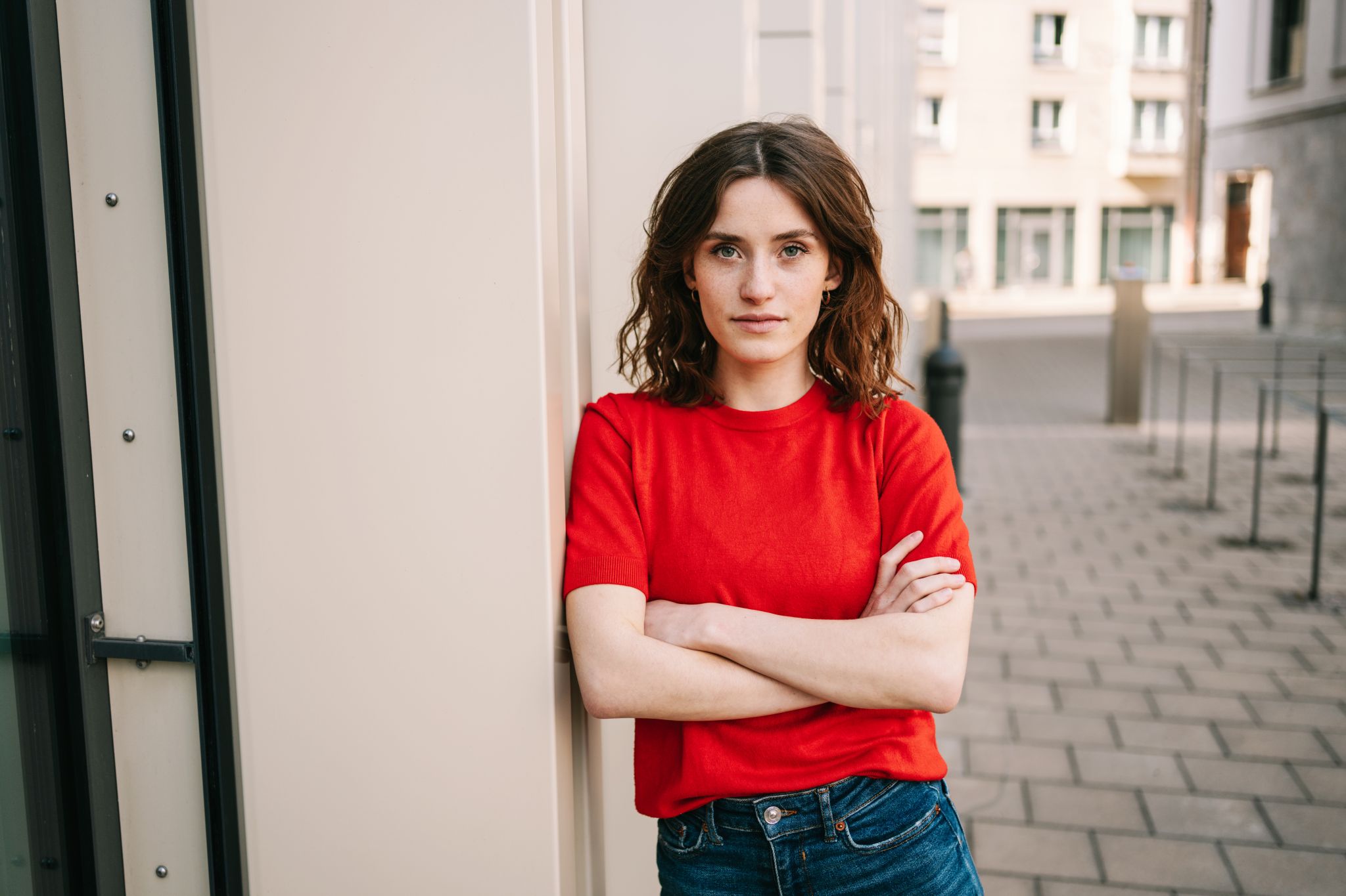 Young woman in red shirt, self-confident